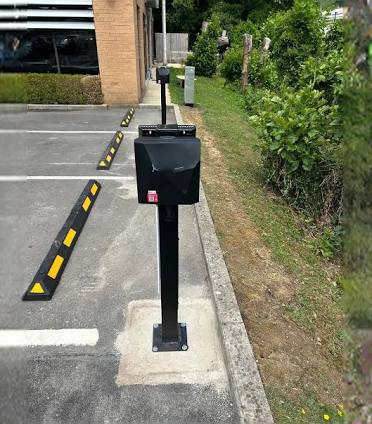 Pedestal-mounted EV charger installed in a school car park by 3 Core Group