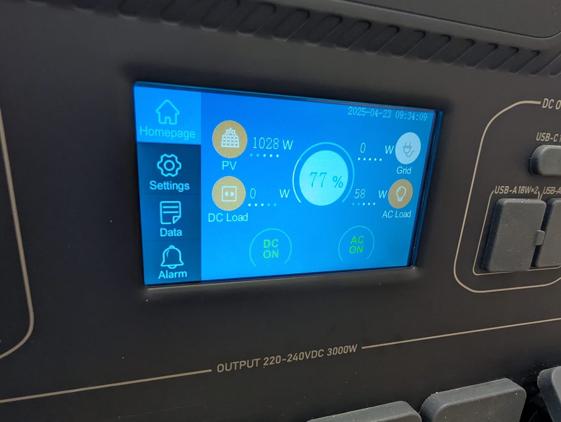 Solar hybrid inverter showing 1028W PV generation and 77% battery